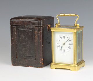 A 19th Century 8 day striking carriage clock contained in a gilt metal case, the enamelled dial with Roman numerals marked Harrods Ltd, London SW1, Made in Paris 12cm x 12cm x 8cm complete with key and leather travelling case 