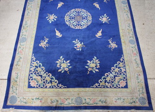 A 1930's Chinese blue and floral patterned carpet 540cm x 352cm 
