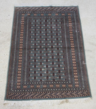A green ground Bokhara rug with numerous diamonds to the centre within a multi row border 182cm  x 125cm 