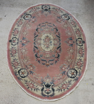 An oval pink ground and floral pattern Chinese rug 274cm x 199cm (fringe reduced) 
