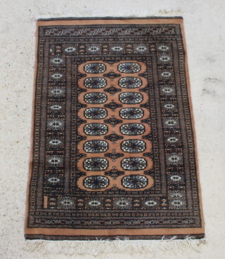 A tan ground Bokhara rug with 16 octagons to the centre within a multi row border 141cm x 92cm 