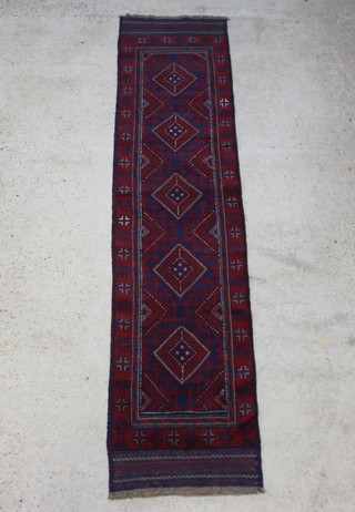 A red and blue ground Meshwani runner with 5 diamonds to the centre within a multi row border 263cm x 59cm 