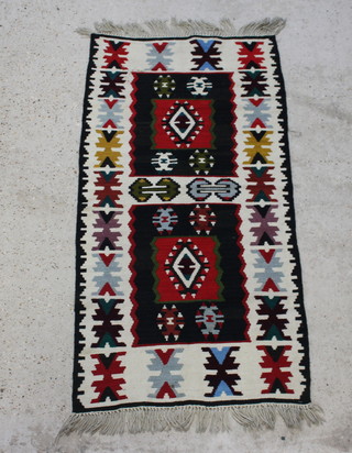 A white, black, red and blue ground Turkish Kilim rug 140cm x 74cm 