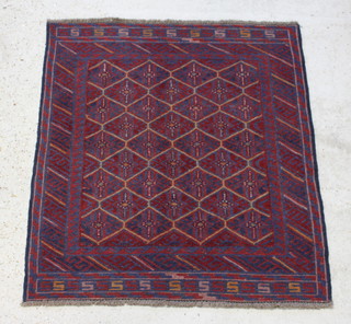 A red and blue ground Gazak rug with numerous diamonds to the centre in a multi-row border 126cm x 110cm 