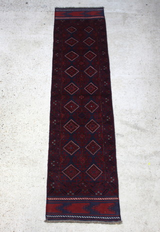 A red and blue ground Meshwani runner with 18 stylised diamonds to the centre 267cm x 64cm 