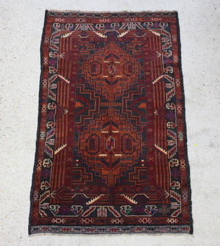 A brown and black ground Belouche rug with 2 stylised diamonds to the centre within a multi row border 183cm x 108cm 