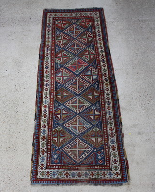 An Antique Caucasian runner with 7 diamonds to the centre within multi row borders 298cm x 111cm 