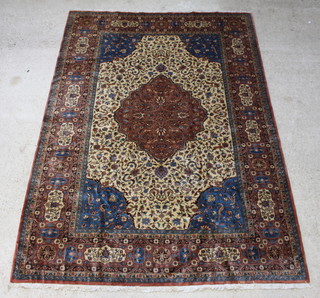 A brown and blue ground Tabriz carpet with central medallion 324cm x 227cm 