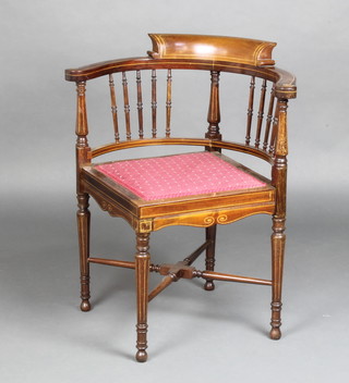 An Edwardian inlaid mahogany tub back corner chair with spindle decoration and upholstered seat, raised on turned supports with X framed stretcher 