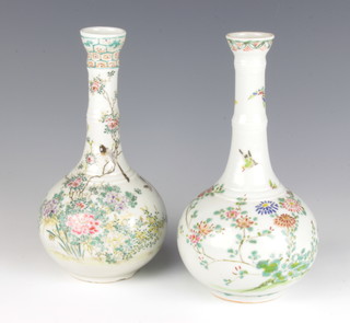 A near pair of Japanese bottle vases decorated with birds amongst flowers 25cm 