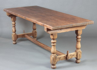 A French rectangular pine refectory table raised on turned supports with H framed stretcher 75cm h x 201cm l x 80cm w