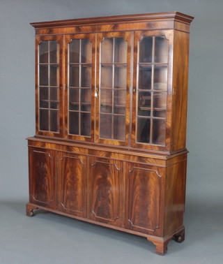 A Georgian style mahogany bookcase on cabinet, the upper section with moulded cornice fitted adjustable shelves enclosed by 4 astragal glazed panelled doors, the base fitted 4 cupboards enclosed by panelled doors raised on bracket feet 185cm h 150cm w x 40cm d 
