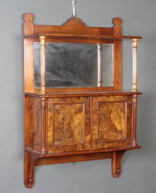 A Victorian walnut and burr walnut hanging cabinet with raised back fitted a mirror, the base enclosed by panelled doors with column decoration to the sides 83cm x 53cm x 20cm 