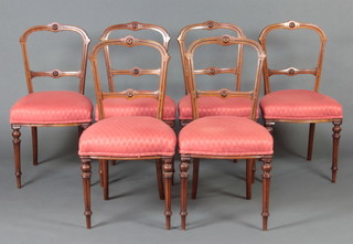 A set of 6 Victorian bleached walnut hoop back dining chairs with carved mid rails and over stuffed seats, raised on turned supports 