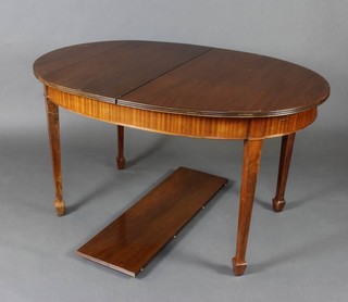 An Edwardian walnut oval extending dining table raised on square tapered supports, spade feet 75cm h x 100cm w x 137 l x 167 when extended  