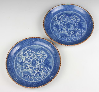 A pair of Chinese blue and white shallow dishes decorated with dragons amongst clouds 26cm 