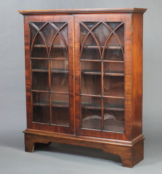 A 19th Century mahogany bookcase with moulded cornice, fitted shelves enclosed by astragal glazed panelled doors, raised on bracket feet 140cm h x 122cm w x 31cm d 