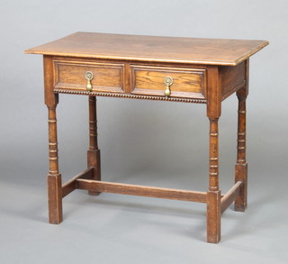 An 18th Century style oak side table with geometric moulding fitted 2 short drawers with pear drop handles, raised on turned and block supports with H framed stretcher 76cm x 91cm x 51cm 