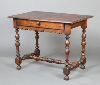 An 18th Century Continental walnut side table, the top formed of 4 planks fitted a drawer, raised on turned and block supports with H framed stretcher 74cm x 98cm x 61cm 