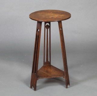 In the manner of Voisy, a circular Art Nouveau oak 2 tier occasional table/plant stand raised on 3 pierced panel supports with triangular undertier 75cm x 41cm diam. 