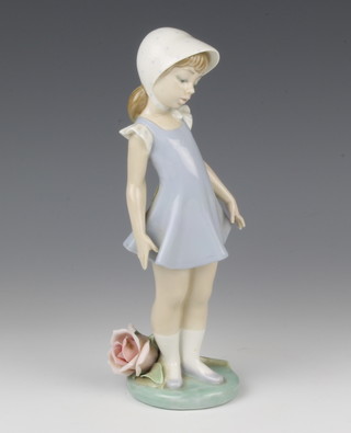 A Lladro figure of a young girl with a large rose at her feet 24cm 