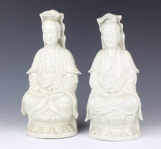 A pair of Chinese blanc de chine figures of seated ladies raised on lotus bases 30cm 