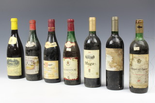 A bottle of 1988 Nuits Saint-Georges Les Pruliers, a bottle of 2000 Muga Rioja, a bottle of 2002 Muga Rioja, a bottle of Marques Del Romeral Rioja, a bottle Fuenmayor Rioja, a bottle of Chino Rouge and a bottle of 2002 Hamilton Reserve vineyard Chardonnay ,  