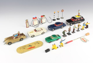 A Corgi Toys 261 James Bond Aston Martin model car in gold complete with ejector figure and 2 others - play worn, a Corgi 258 Saints Volvo P1800 - play worn, a Corgi 218 Aston Martin DB in blue, a Dinky 172 Fiat 2300 station wagon (camera missing), a Matchbox Series no.73 Ferrari Berlinetta, 8 various film crew figures, petrol pumps, etc 