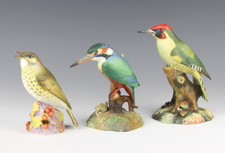 Two Royal Crown Derby birds Woodpecker 17cm and King Fisher 14cm, together with a Royal Worcester Thrush 3234 13cm  