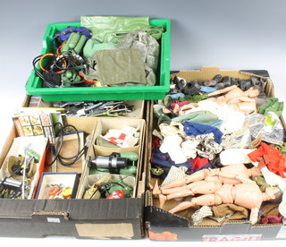 Four 1964 Action Man figures together with various Action Man uniforms, clothing, boots and hats, two small boxes of Action Man guns, hand grenades, respirator, belts,	a quantity of Action Man accessories including Action Man Jungle Expedition, Arctic Expedition and diving, etc