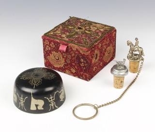 A Japanese circular metal bowl with character decoration 4cm x 8cm contained in a plush box and 2 bottle stoppers
