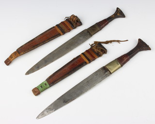 Two Eastern double edged daggers with 20cm and 22cm blades contained in leather scabbards 