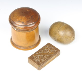 A 19th Century Swiss carved wooden matchbox marked Murren, with secret opening mechanism 1cm x 7cm x 4cm, a cylindrical turned treen jar and cover (chip to lid) 7cm x 7cm, a turned "string box" in the form of an acorn 7cm x 4cm  