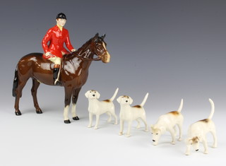 A Beswick figure of a huntsman on horseback with brown gloss finish 21cm together with 4 hounds 