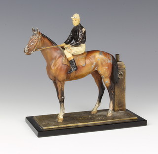 A cold painted spelter table lighter in the form of a race horse with jockey up, complete with striker 14cm x 17cm x 8cm 