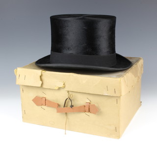 A gentleman's black silk top hat by Dunn & Company size 7 1/8 (very slight wear to the top) complete with box PLEASE NOTE THE SIZE OF THIS HAT IS 7 1/8 (originally catalogued as 7 3/8) 