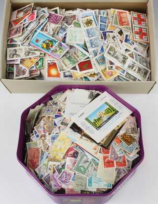 Two boxes of loose world stamps on paper 