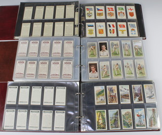 Three albums of cigarette cards including Wills, Players, Carreras, Ogdens, Churchmans