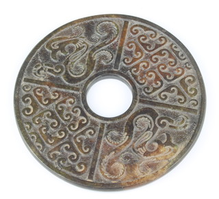 A circular Oriental carved hardstone dish with hole to the centre, 15cm 