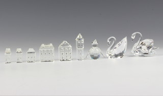 Two Swarovski Crystal swans 6cm and 3cm, a ditto penguin 3cm and 6  buildings, boxed 
