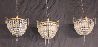 Three circular gilt metal bag shaped light fittings hung lozenges 28cm h x 27cm diam. 