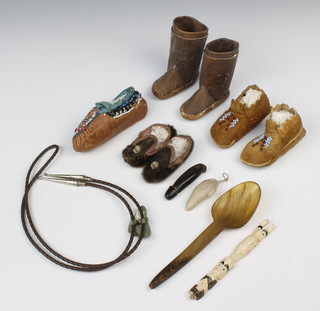 A pair of leather moccasins 8cm x 4cm, 1 other 8cm x 2cm, a single ditto 10cm x 3cm, a pair of leather boots 8cm x 8cm, a carved wooden spoon and other curios 