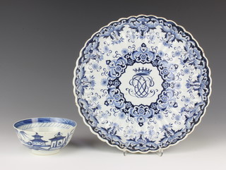 A19th Century Dutch Delft scallop dish with centre armorial enclosed by flowers 27cm together with a Delft bowl with landscape view 12cm 
