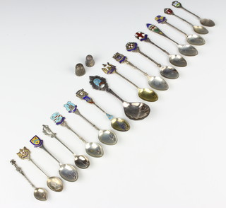 A collection of enamelled and other silver collectors spoons and thimbles, 198 grams 