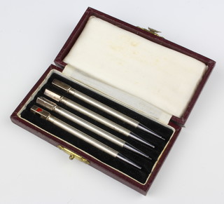 A set of 4 Sterling silver engine turned bridge pencils, cased
