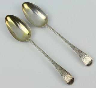 A pair of William IV silver dessert spoons with chased handles and monogram London 1831, maker Benjamin Davis 62 grams