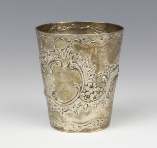 A Continental repousse silver beaker with scroll and floral decoration and vacant cartouche 8cm, 87 grams