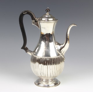 A Victorian silver demi-fluted coffee pot with chased armorial and ebony mounts, London 1899, maker William Hutton & Sons Ltd 27cm, gross 630 grams 
