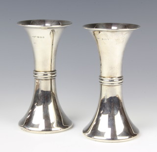 A pair of Edwardian silver waisted vases with flared bases, Birmingham 1910, maker Maurice Gratz & Co 16cm, 275 grams 