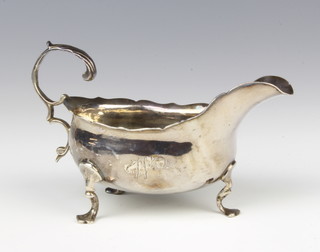 A George III silver sauce boat with S scroll handle on hoof feet London 1765, 88 grams 